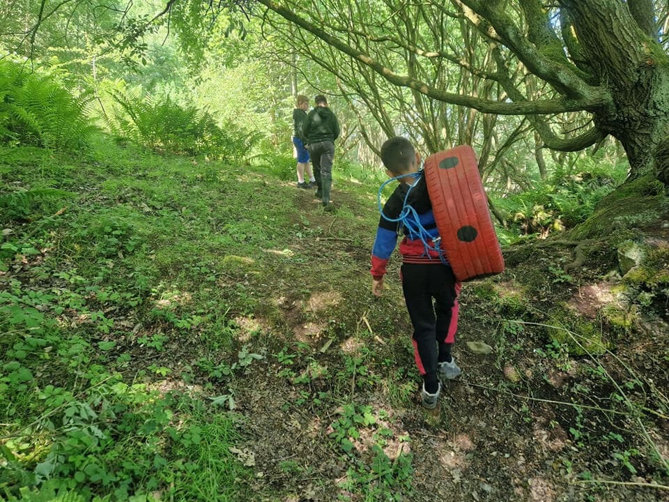 Children exploring the forest during Fern Outdoor Adventures forest school