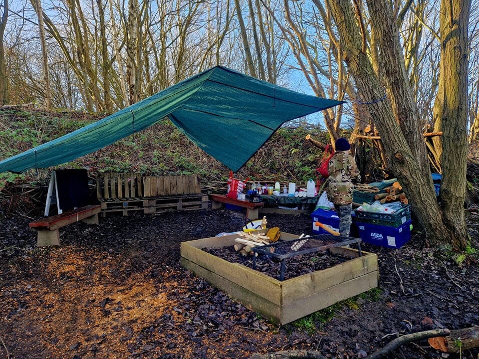 Woodland classroom setup – tarps, fire pit and benches